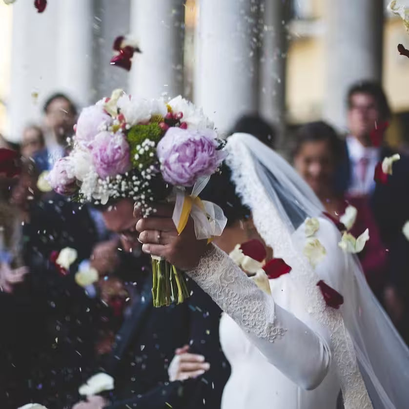 A couple showing off some flowers they just got married